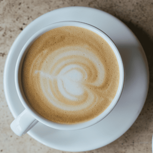 Speciality coffee being poured into a cup at Lavi Café in London, served with fresh croissants.